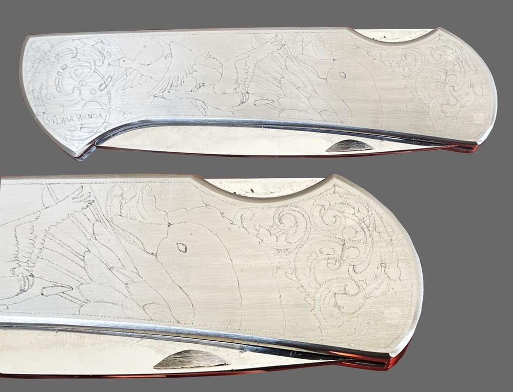 Folding knife with the design scribed onto the steel handle
