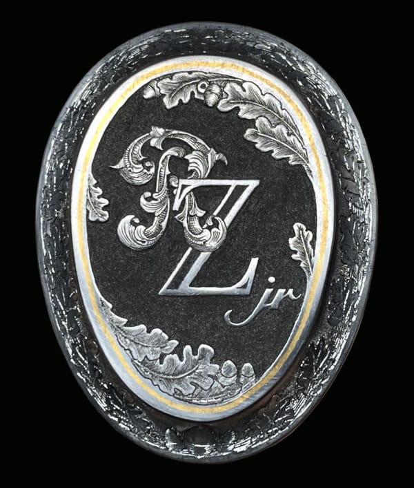 Griffkappe mit graviertem Monogramm in goldenem Rahmen